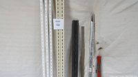 Five metal rails: 3 white perforated shelving rails approximately 72 inches, 2 longer rails (one black, one silver) and a thinner red rail seen on floor.