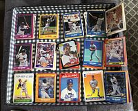 Multiple baseball cards laid out showing player images, names, and team logos from 1987 and later.