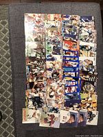 Top view of fifty 1990-1991 NFL Pro-Set football trading cards arranged in rows showing various players and referees in uniforms, cards in near mint condition