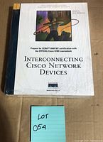 Front cover of 'Interconnecting Cisco Network Devices' book with title and artwork visible.