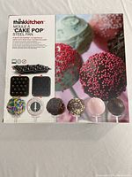 Box of Thinkkitchen steel cake pop pan with product image and usage examples on packaging.