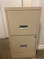 Front view of the filing cabinet showing two drawers with recessed handles and lock.