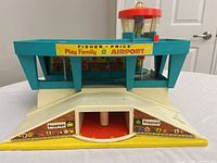Front view of Fisher Price Play Family Airport showing baggage claim areas and control tower base.