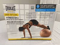 Photo shows Everlast Fit fitness ball box with product details and warranty information.