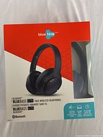 Photo shows the Blue Hive BlueBass Elite headphone packaging with visible product image, brand and model name, and key features.
