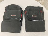 Pair of black Schwinn pannier bike bags shown side by side on white surface