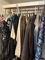 Closet hanging clothes item overview showing various garments and colors