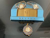 Group view showing three watches and display stand