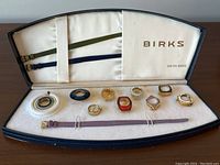 Opened box showing straps, bezel inserts and watch head
