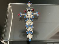 Front view of Jay Flex brooch showing clear baguette rhinestones with red and blue round rhinestones arranged in sword shape.