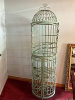 Full view of closed birdcage bar showing dome top and decorative scrolling