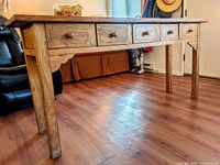 Full side view of 6-foot wide hardwood side table showing five drawers and table legs.
