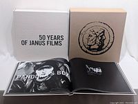 Slipcase and inner white case with hardcover book laid open.