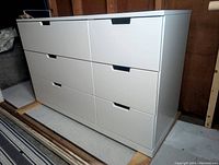 Front view of white IKEA dresser showing all six drawers closed.