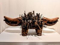 Front view of entire two-headed dog effigy on white background showing full form