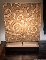 Lamp with abstract swirl pattern illuminated