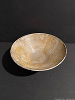 Photo showing inside view of the pottery bowl with natural earthy texture and coloration.