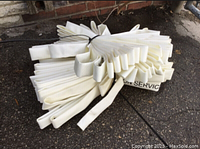 Photo showing one set of white heavy duty woven fire hose folded and secured with a zip tie. Markings partially visible on hose material.