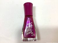 Bottle of Sally Hansen Insta-Dri Prismatic nail polish in shade 050 The Future Is Fuchsia showing front label.