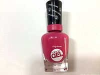 Bottle of Sally Hansen Miracle Gel Nail Polish in pinkish-red color with black cap, showing front label.