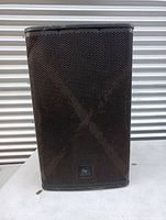 Front view of black Electro-Voice ELX 115P speaker with metal grille and EV logo