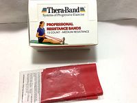 Box of Thera-Band Professional Resistance Bands 15 count medium resistance with one red band outside the box