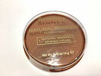 Top view of Rimmel London Natural Bronzer with clear lid showing product and branding text.