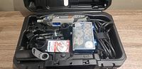 Open case showing Dremel 4300 rotary tool, accessories and attachments inside the molded compartments.