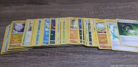 Spread of assorted Pokémon cards showing various characters and card types including Electric and Fire Pokémon.