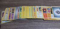 Loosely stacked assortment of Pokemon cards including multiple visible Fighting Energy cards and various Trainer and Pokemon creature cards.