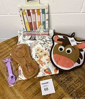 Photo of Disney Parks kitchen and garden items including an Ink & Paint style dish towel, Bullseye pot holder, Pooh wooden spoon holder, Figment spork, and garden markers