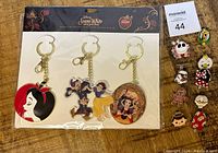 Full lot showing Snow White keychain set and Disney trading pins.