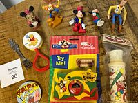 Lot of various vintage Disney character figurines, toys, and collectibles including Mickey Mouse, Minnie Mouse, Woody, Goofy, and Winnie the Pooh.