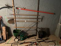 Full view of garden lot items leaning against wall and placed on floor
