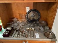 Full lot on countertop including glassware and silver plate items