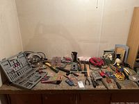 Photo of table with assorted power and hand tools including SkilSaw circular saw, jigsaw, hand tools and electrical items