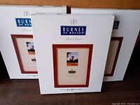 Three boxed Burns of Boston State Street 8x10 photo frames stacked upright showing front of packaging with branding and photo frame depiction