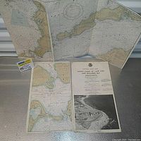 Photo showing the vintage nautical chart unfolded with Cape Cod and Buzzards Bay coastal regions visible, along with a separate informational sheet and a small white label.