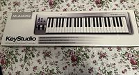 Photo of M-Audio KeyStudio keyboard controller box showing model and features