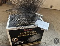 Imperial Supersweep Chimney Brush shown on its original box, dense wire bristles visible.