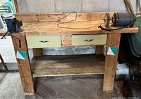 Work table showing full front view with vise mounted left and bench grinder on right, highlighting drawers and work surface