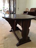 Side angle view of the Ethan Allen drop leaf side table showing its base and one extended drop leaf.