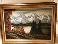 Full view of framed mountain lake landscape painting