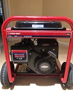 Front view of red tubular frame housing engine and wheels