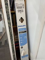 Four Philips fluorescent T8 tube lights in original packaging, showing label details with wattage and length.