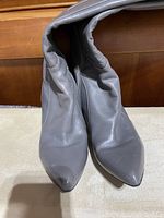 Top view of the pair of grey Nine West boots showing the pointed toe design and leather material.