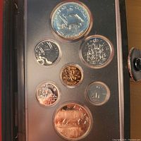 Photo showing full coin set in vitrified case, front side with various Canadian coins