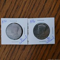 Obverse side of two 1976 Bi-centennial Kennedy Half Dollar coins showing JFK portrait and bi-centennial dates.