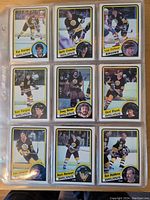 Page displaying nine Boston Bruins hockey cards from 1984-85 OPC series.