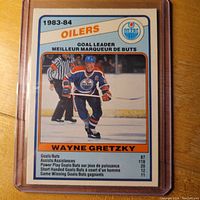 Front side of 1983-84 OPC Wayne Gretzky hockey card showing Gretzky in Oilers uniform with goal leader stats.